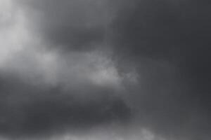 Cloudscape scenery, overcast weather above dark blue sky. Storm clouds floating in a rainy dull day with natural light. White and grey scenic environment background. Nature view. photo