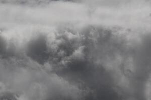 Cloudscape scenery, overcast weather above dark blue sky. Storm clouds floating in a rainy dull day with natural light. White and grey scenic environment background. Nature view. photo