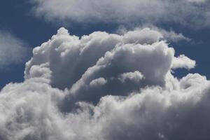 Cloudscape scenery, overcast weather above dark blue sky. Storm clouds floating in a rainy dull day with natural light. White and grey scenic environment background. Nature view. photo
