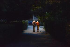 senior couple walking on the street. view from behind photo