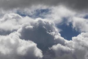 Cloudscape scenery, overcast weather above dark blue sky. Storm clouds floating in a rainy dull day with natural light. White and grey scenic environment background. Nature view. photo