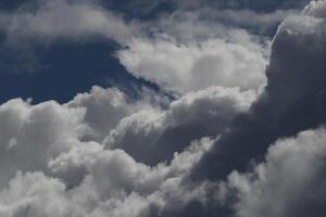 Cloudscape scenery, overcast weather above dark blue sky. Storm clouds floating in a rainy dull day with natural light. White and grey scenic environment background. Nature view. photo