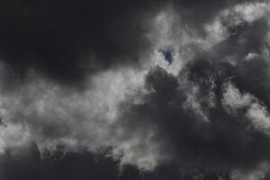 Cloudscape scenery, overcast weather above dark blue sky. Storm clouds floating in a rainy dull day with natural light. White and grey scenic environment background. Nature view. photo