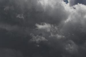 Cloudscape scenery, overcast weather above dark blue sky. Storm clouds floating in a rainy dull day with natural light. White and grey scenic environment background. Nature view. photo