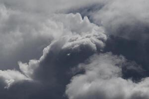 Cloudscape scenery, overcast weather above dark blue sky. Storm clouds floating in a rainy dull day with natural light. White and grey scenic environment background. Nature view. photo