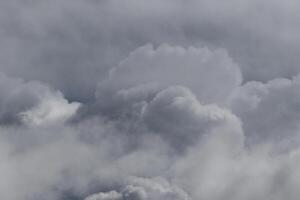 Cloudscape scenery, overcast weather above dark blue sky. Storm clouds floating in a rainy dull day with natural light. White and grey scenic environment background. Nature view. photo