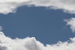 Cloudscape scenery, overcast weather above dark blue sky. Storm clouds floating in a rainy dull day with natural light. White and grey scenic environment background. Nature view. photo