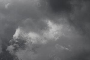 Cloudscape scenery, overcast weather above dark blue sky. Storm clouds floating in a rainy dull day with natural light. White and grey scenic environment background. Nature view. photo