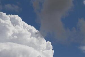 Cloudscape scenery, overcast weather above dark blue sky. Storm clouds floating in a rainy dull day with natural light. White and grey scenic environment background. Nature view. photo