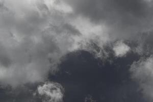 Cloudscape scenery, overcast weather above dark blue sky. Storm clouds floating in a rainy dull day with natural light. White and grey scenic environment background. Nature view. photo