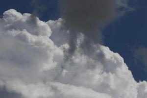 Cloudscape scenery, overcast weather above dark blue sky. Storm clouds floating in a rainy dull day with natural light. White and grey scenic environment background. Nature view. photo