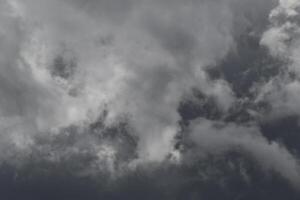 Cloudscape scenery, overcast weather above dark blue sky. Storm clouds floating in a rainy dull day with natural light. White and grey scenic environment background. Nature view. photo