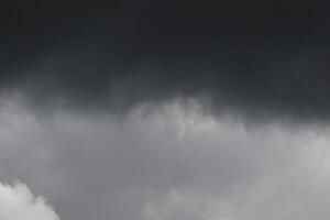 Cloudscape scenery, overcast weather above dark blue sky. Storm clouds floating in a rainy dull day with natural light. White and grey scenic environment background. Nature view. photo