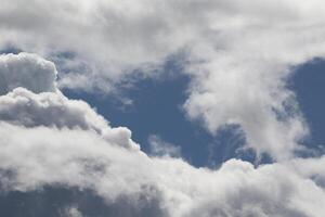 Cloudscape scenery, overcast weather above dark blue sky. Storm clouds floating in a rainy dull day with natural light. White and grey scenic environment background. Nature view. photo