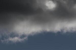 Cloudscape scenery, overcast weather above dark blue sky. Storm clouds floating in a rainy dull day with natural light. White and grey scenic environment background. Nature view. photo