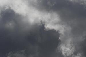 Cloudscape scenery, overcast weather above dark blue sky. Storm clouds floating in a rainy dull day with natural light. White and grey scenic environment background. Nature view. photo