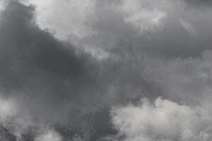 Cloudscape scenery, overcast weather above dark blue sky. Storm clouds floating in a rainy dull day with natural light. White and grey scenic environment background. Nature view. photo
