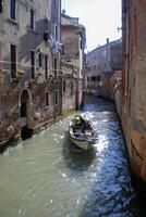 Venice Grand Canal, with its iconic winding waterway flanked by historic buildings and bustling activity, epitomizes the charm and allure of the enchanting city of Venice photo