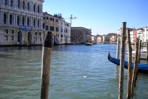 Venice Grand Canal, with its iconic winding waterway flanked by historic buildings and bustling activity, epitomizes the charm and allure of the enchanting city of Venice photo