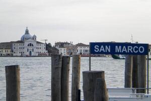 Venice Grand Canal, with its iconic winding waterway flanked by historic buildings and bustling activity, epitomizes the charm and allure of the enchanting city of Venice photo