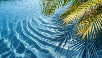 Shadows of palm leaves on Rippling blue Water Surface, tropical background photo