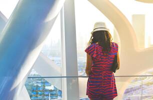 Dubai, UAE - 14th october, 2022 - caucasian tourist in famous Frame landmark enjoy panorama of city skyline. Visit UAE holiday travel destinations in Dubai concept photo