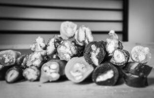 Black and white Macro close up of Various types of sliced peaces of Churchkhela with bank space background. Georgian fruit snacks concept. photo