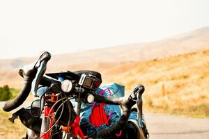 Background image of standing touring bicycle without cyclist on the road with nocars. Cycling in a countryside. Kazkbegi national park. Georgia.2020 photo