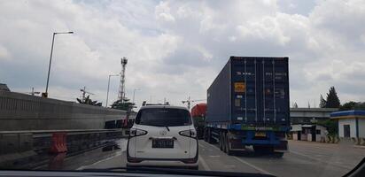 Jakarta, Indonesia in August 2019. Rear view photo of a car and box truck that are in a toll road jam.