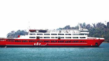 Merak, Indonesia on June 8 2023. A red ferry boat is heading towards the port of Merak. photo