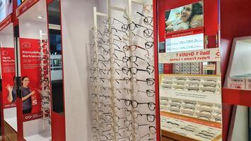 Bekasi, Indonesia on December 12 2023. Several glasses are neatly arranged in an glasses shop window. photo