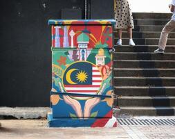 Kuala Lumpur, Malaysia on May 22, 2023. An electrical panel decorated with paintings of the Malaysian flag and landmarks. photo