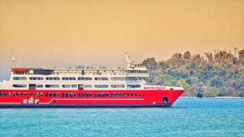 Merak, Indonesia on June 8 2023. A red ferry boat is heading towards the port of Merak. photo