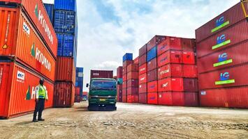 Jakarta, Indonesia on December 6, 2023. Stacks of colorful containers at a logistics warehouse in Cakung. photo