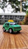 Toy cars in the shape of a green TAXI. Suitable for boys photo