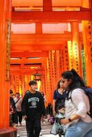 Kyoto, Japan in April 2019. Tourists taking pictures and walking in the Fushimi Inari are photo