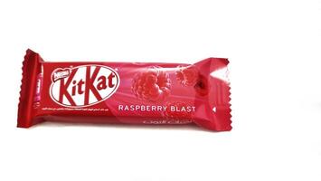 Medina, Saudi Arabia on February 29 2024. 2 finger KitKat chocolate with raspberry blast flavor, with Arabic writing. A signature crispy wafer center, balanced with smooth milk chocolate, raspberry. photo