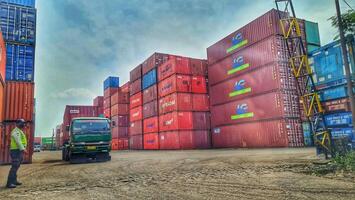 Jakarta, Indonesia on December 6, 2023. Stacks of colorful containers at a logistics warehouse in Cakung. photo