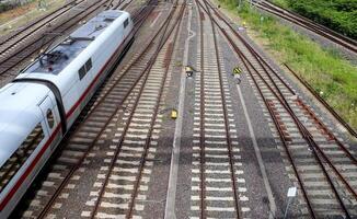 Multiple railroad tracks with junctions at a railway station in a perspective and birds view photo