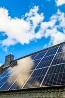 Solar panels producing clean energy on a roof of a residential house photo