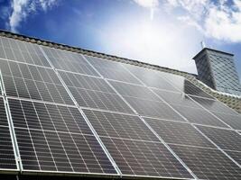 Solar panels producing clean energy on a roof of a residential house photo