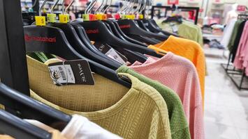 Bekasi, Indonesia on December 20, 2023. Rows of hangers with the words several women's clothes hanging on them photo