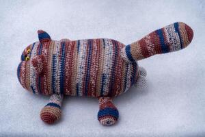 Crocheted toy cat. Melange thread. Hobby knitting. Funny animal. photo