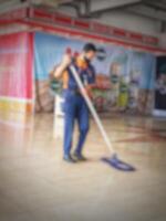 Jakarta, Indonesia on July 7 2022. A cleaner at Halim Perdanakusuma Airport. This officer is cleaning the airport floor so that it is clean and not slippery. photo