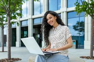 Focused professional working on a laptop in a casual outdoor setting, embodying modern work flexibility. photo