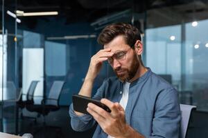 Mature man in office upset with game on smart phone, disappointed businessman from home playing casino games on phone, lost. photo