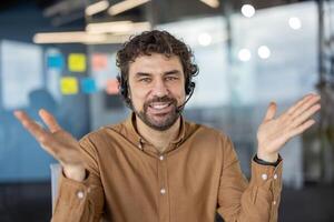 A professional appears confused and shrugs in an office environment, portraying uncertainty or questioning. photo