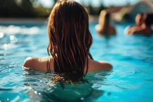 A swimming pool with some hot women in the blurred background. photo