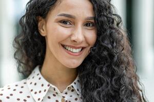 A detailed image showcasing the texture and pattern of curly hair and a polka-dotted garment. The soft focus gives the picture a delicate and stylish look suitable for diverse uses. photo