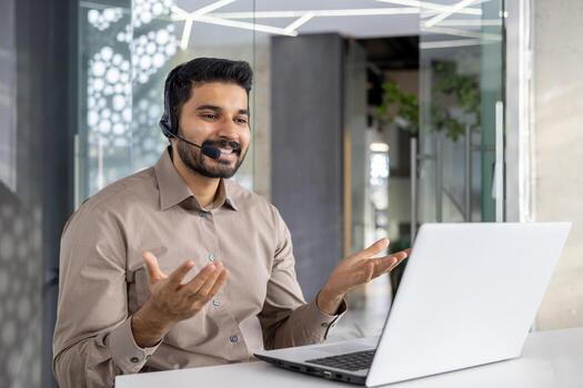 A cheerful customer service representative talks using headset in a modern office setting, assisting clients with expertise and a smile photo